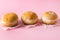 Three Berliner Doughnuts European Donuts Tradicional Bakery for Fasching Carneval Time Horizontal Pink Background