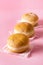 Three Berliner Doughnuts European Donuts Tradicional Bakery for Fasching Carneval Time Vertical Pink Background