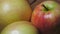 Three big beautiful apples on a rotating surface, close-up