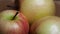 Three big beautiful apples on a rotating surface. Macro video