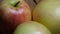 Three big beautiful apples on a rotating surface. Macro video. Fruit rotation