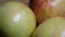 Three big beautiful apples on a rotating surface. Macro video. Fruit rotation close-up