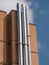 Three Big Vertical Steel Pipes attached to the Exterior Wall of a Building