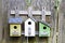 Three birdhouses on old wooden fence