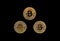 Three bitcoin coins on black background. Concept of wealth, Btc, economy, money, anonymity