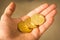 Three bitcoin coins in a hand close up