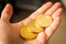 Three bitcoin coins in a hand close up