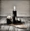 Three black candles and old manuscript with pentagram on wooden table