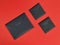 Three black cardboard envelope on red background