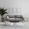 Three blank vertical wooden poster frame mock up in modern minimalist living room interior with gray sofa and palm tree, living