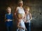 Three blonde brothers pose in Studio next to their mother. Boys and a woman with white bleached hair. family is happy together