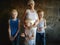 Three blonde brothers pose in Studio next to their mother. Boys and a woman with white bleached hair. family is happy together