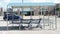 three blue shopping grocery carts outside outdoors in summer loosely inside each