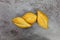 Three bolillo bread rolls on a gray mottled background