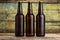 Three bottles of beer against wooden background