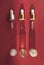 Three bottles of cosmetic pipettes. Red background, hard shadow. Skin care. Flat lay. Top view