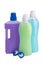 Three bottles of liquids of different colors, for cleaning and two capsules for washing, on a white background