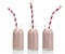 Three Bottles of pink milk with red and white striped straws