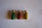 Three bottles with red, green, yellow glitter on white background. Top view. Hobby, decor ingredient.