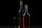 Three bottles with various alcoholic drinks on a dark background