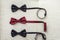 Three bow ties, two black and one red. Team work, career, hipster, wedding concept.