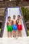 Three boys have fun unter the pool shower