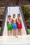 Three boys have fun unter the pool shower