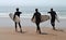 Three boys searching for waves, surfing in Sagres, Portugal