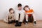 Three boys sit and read book