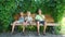 Three boys sitting in park and eating ice cream