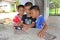 Three boys are watching the interest at a telephone.