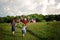 Three boys waving American flags walking in Rural America