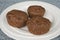 Three bran muffins on white plate