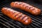 three bratwursts with crisp grill marks on a bbq grill