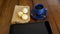 Three Brazilian cheese breads next to a cup of coffee with smoke and tablet