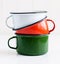 Three bright colorful enameled mugs