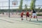 Three brothers playing basketball, one of them has a leg prosthesis