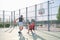 Three brothers playing basketball, one of them has a leg prosthesis