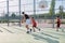 Three brothers playing basketball, one of them has a leg prosthesis