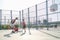 Three brothers playing basketball, one of them has a leg prosthesis.