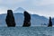 Three Brothers Rocks in Avachinskaya Bay on background Vilyuchinsky Volcano. Kamchatka Peninsula