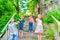 Three brothers and sister stand on the steps in the park and show the class