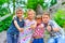 Three brothers and sister stand on the steps in the park and show the class