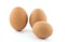 Three brown chicken eggs.