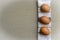 Three brown chicken eggs on a kitchen towel