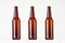 Three brown longneck beer bottles mock up.