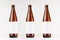 Three brown NRW beer bottles 500ml with blank white label on white wooden board, mock up.