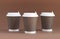 Three brown paper coffee cup with cap