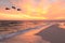 Three Brown Pelicans Fly Near the Beach at Sunset