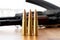 Three bullets against blurred Kalashnikov assault rifle background. Cartridges 7.62 caliber for ak 47 closeup